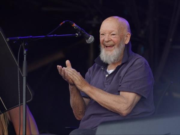 A photo of Michael Eavis on stage at Glasto<em></em>nbury festival.